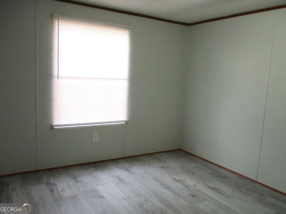 606 Cline Road Northwest Resaca, GA 30735 - Photo 2 of 49 an empty room with wooden floor and a window