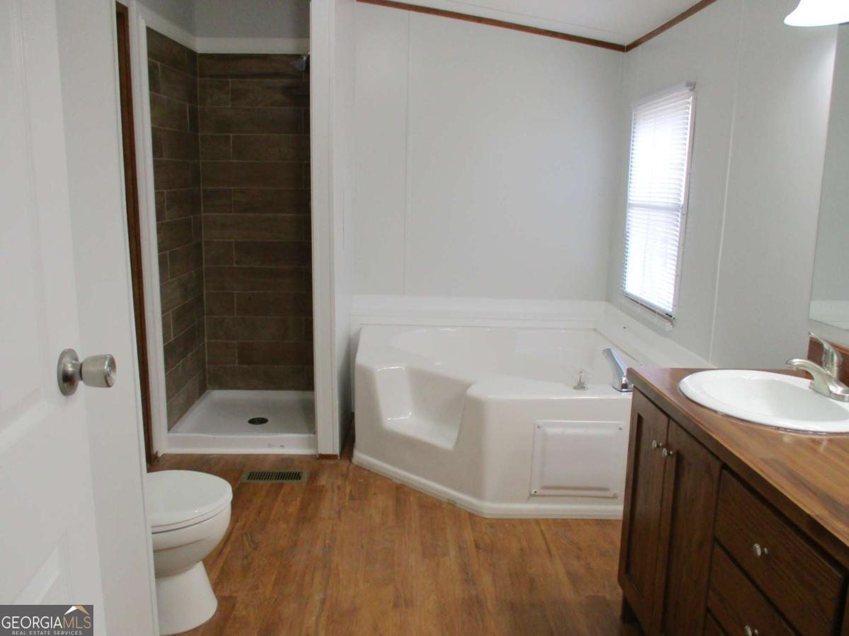 606 Cline Road Northwest Resaca, GA 30735 - Photo 26 of 49 a bathroom with a bathtub shower sink vanity and toilet