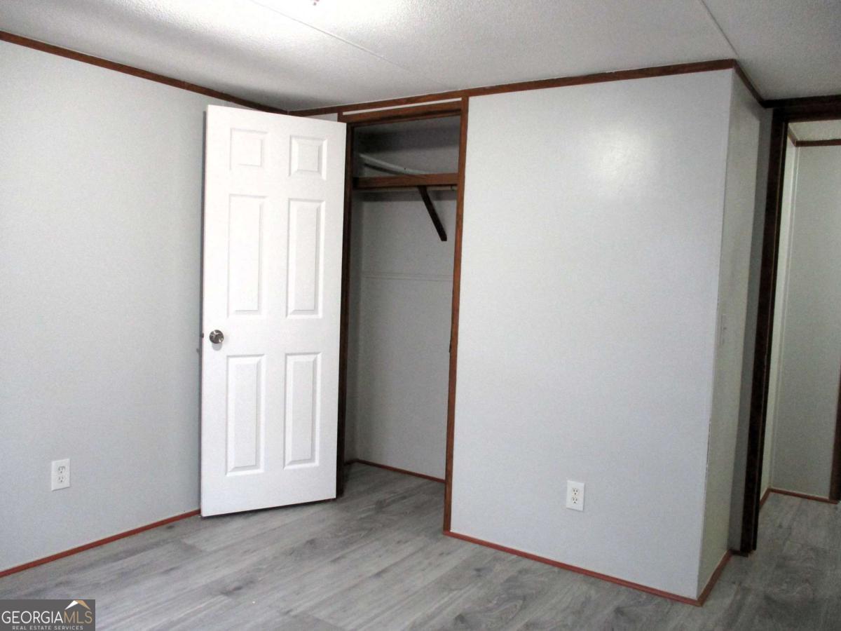 606 Cline Road Northwest Resaca, GA 30735 - Photo 3 of 49 a view of an empty room with wooden floor and a window