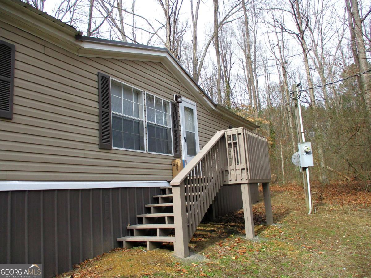 606 Cline Road Northwest Resaca, GA 30735 - Photo 46 of 49 a view of wooden house with a small yard and potted plants