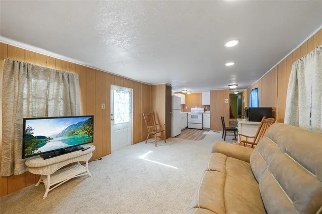 a living room with furniture gym equipment and a flat screen tv