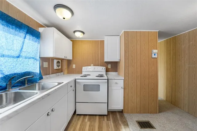 a kitchen with a sink and a refrigerator