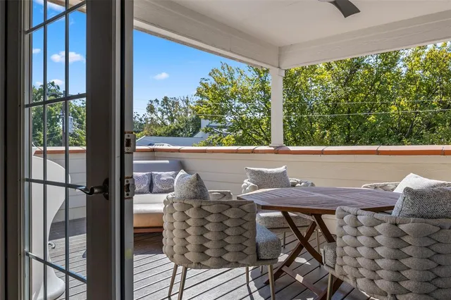 a view of a patio with table and chairs with wooden floor and plants