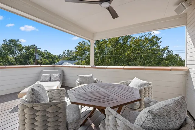 a view of a patio with table and chairs and couches with wooden floor