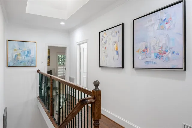a view of a hallway with a painting on the wall