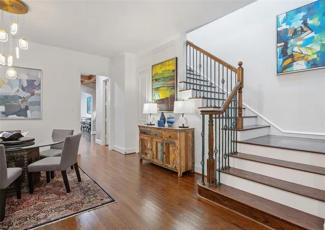 a view of a hallway with wooden floor and furniture