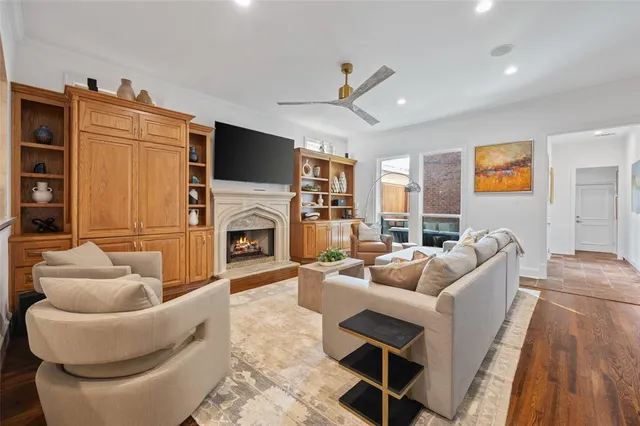 a living room with furniture a fireplace and a flat screen tv