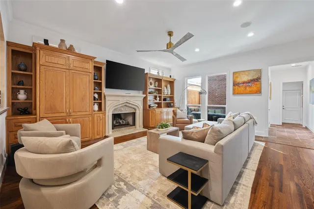 a living room with furniture a fireplace and a flat screen tv