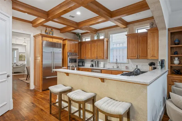 a kitchen with a sink and chairs