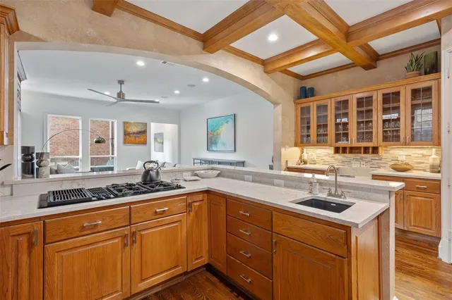 a kitchen with a sink stove and cabinets