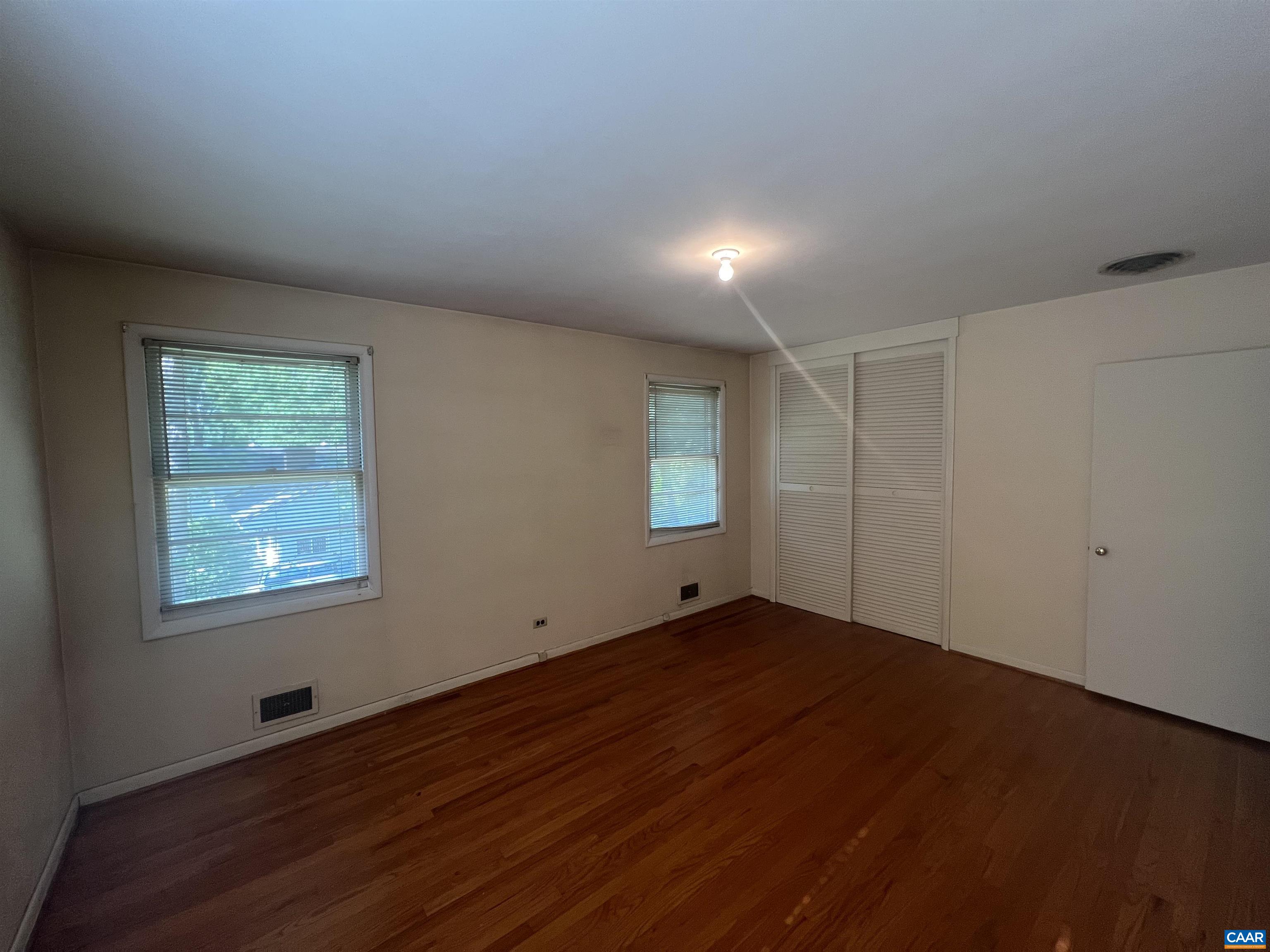 127 North Bennington Road Charlottesville, VA 22901 - Photo 8 of 29 an empty room with wooden floor and windows