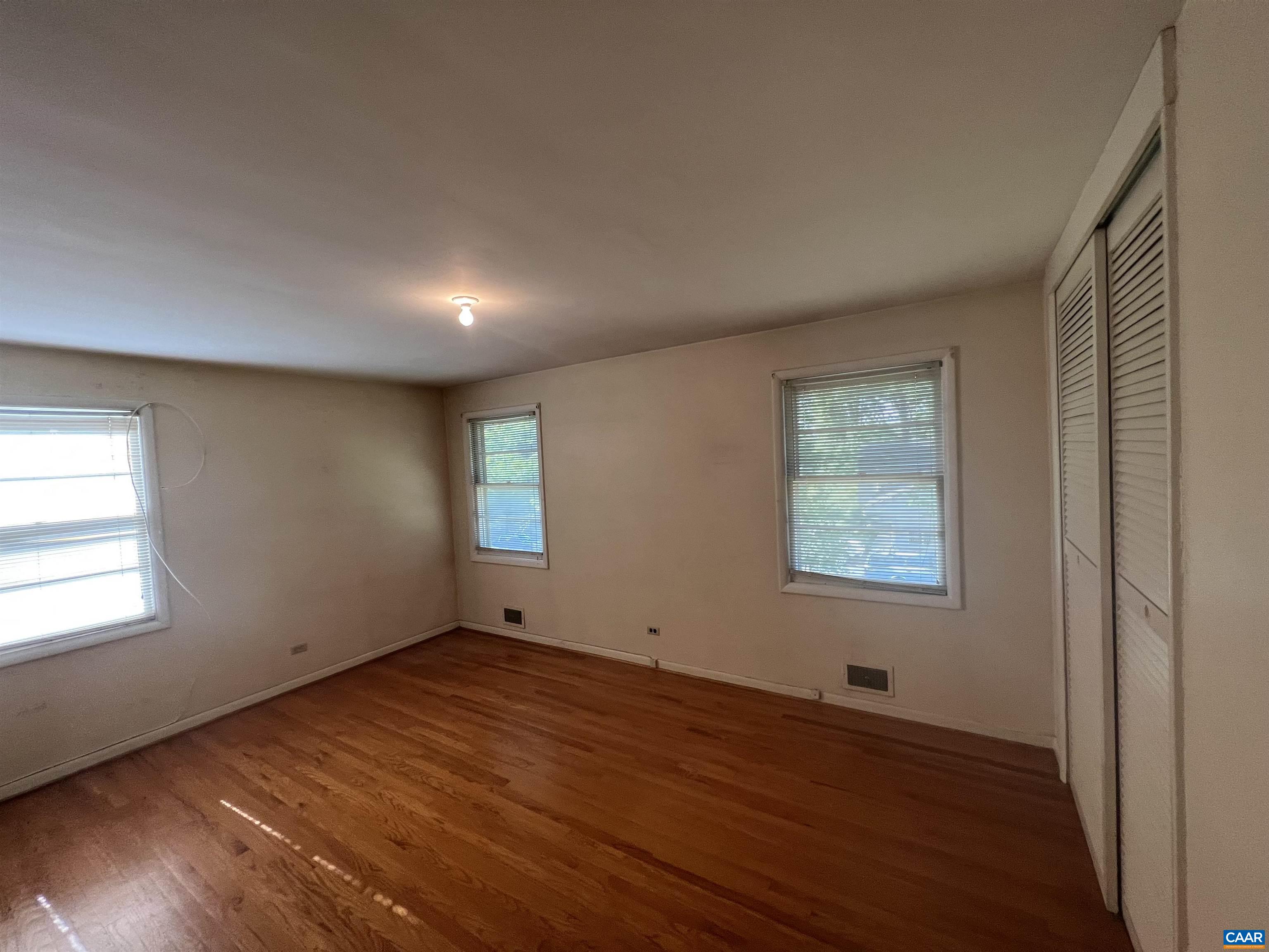 127 North Bennington Road Charlottesville, VA 22901 - Photo 9 of 29 an empty room with wooden floor and windows