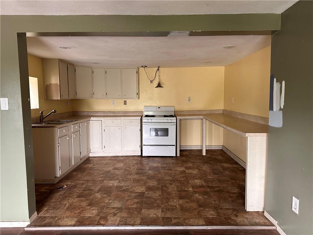 1199 Sharon Road Bridgewater, PA 15009 - Photo 8 of 15 a kitchen with stainless steel appliances granite countertop a stove a sink and a microwave