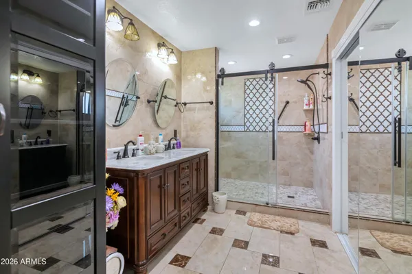a bathroom with a sink vanity and mirror