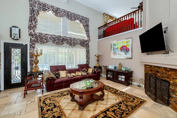 a living room with stainless steel appliances kitchen island granite countertop furniture and a rug