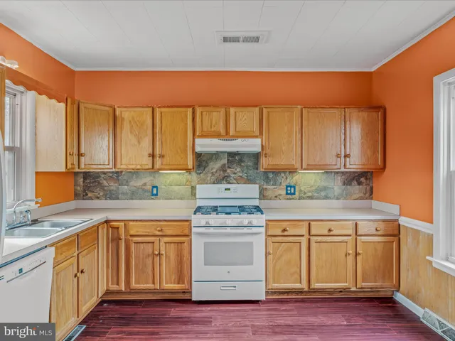 a kitchen with a stove top oven sink and cabinets