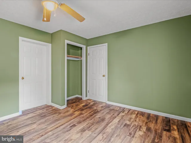 a view of a room with wooden floor and cabinet