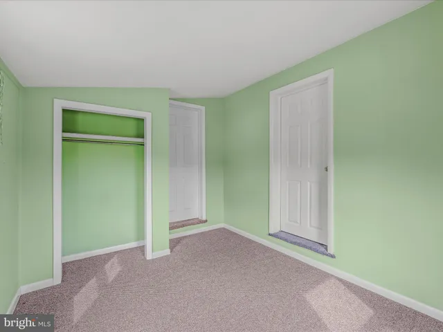 a view of an empty room and closet area