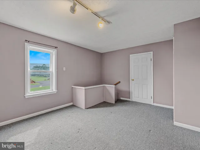 an empty room with windows and closet