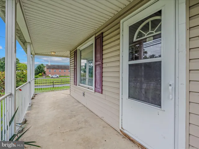 a view of a house with porch and wooden stairs