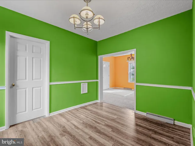 a view of a room with a window and chandelier