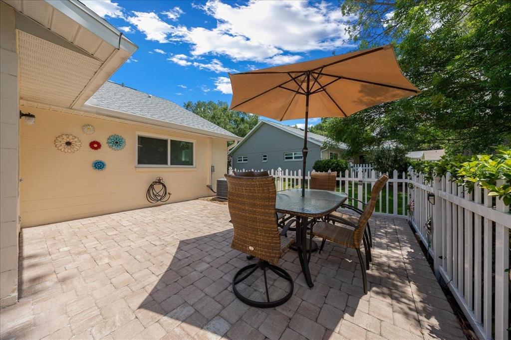 8720 Southwest 90th Street, Unit A Ocala, FL 34481 - Photo 39 of 71 a view of a patio with table and chairs under an umbrella