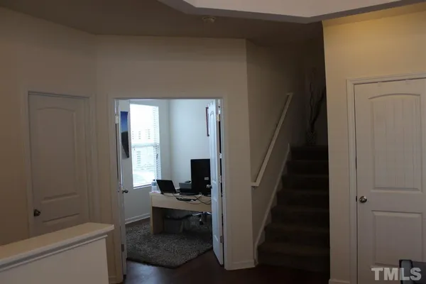 a view of a livingroom with furniture and staircase