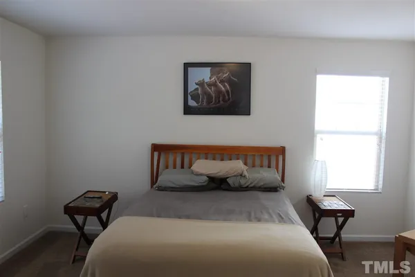 a bedroom with bed and a window