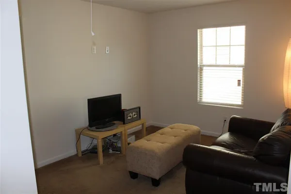 a livingroom with workspace and a window