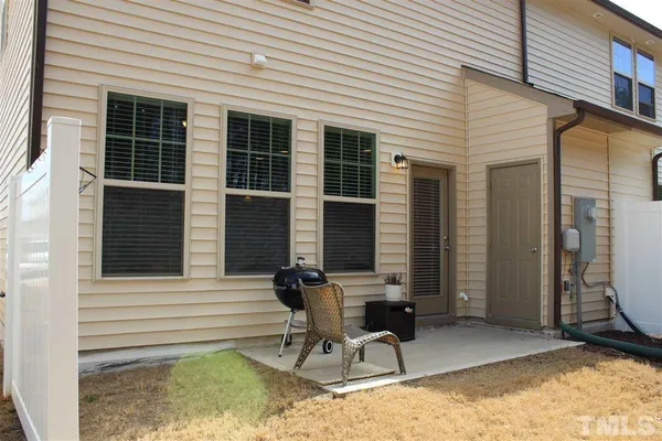 a view of two chairs in the patio