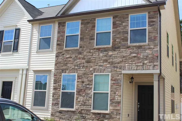 a front view of a building with a brick wall
