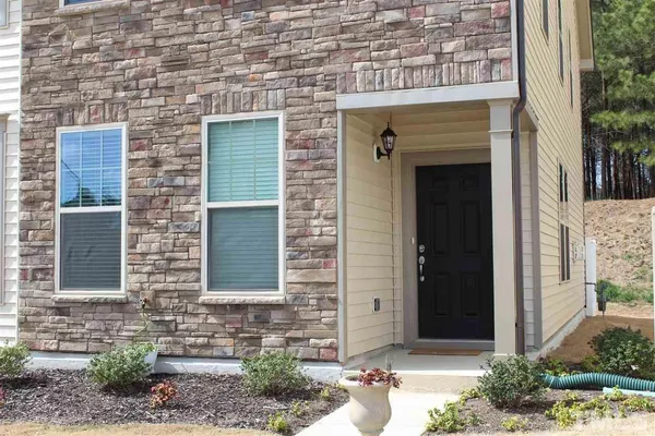 a front view of a house with a yard