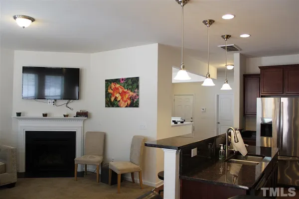 a living room with fireplace furniture and a flat screen tv