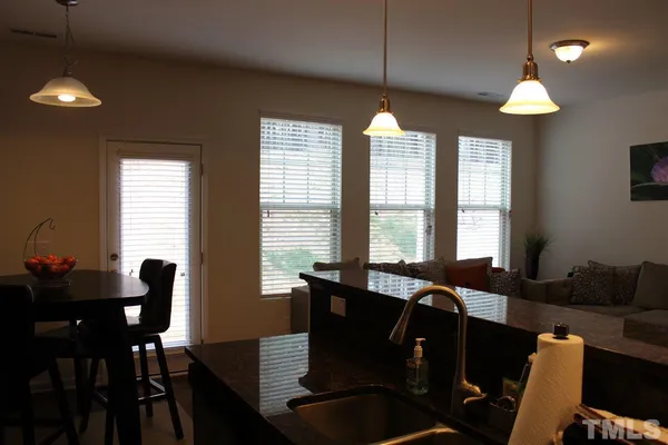 a view of a dining room with furniture and chandelier