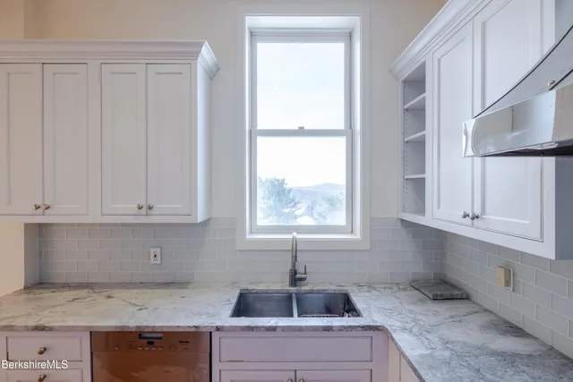 a white toilet sitting next to a bathroom sink