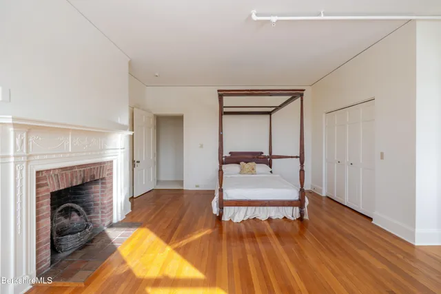 a view of a living room with furniture and a fireplace