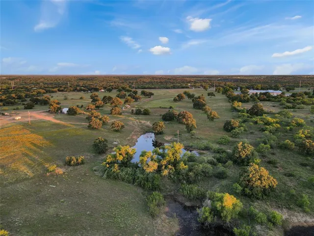 an aerial view of a houses with a lake view