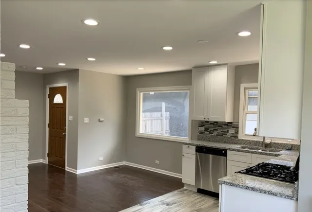 a kitchen with stainless steel appliances granite countertop a stove and a sink