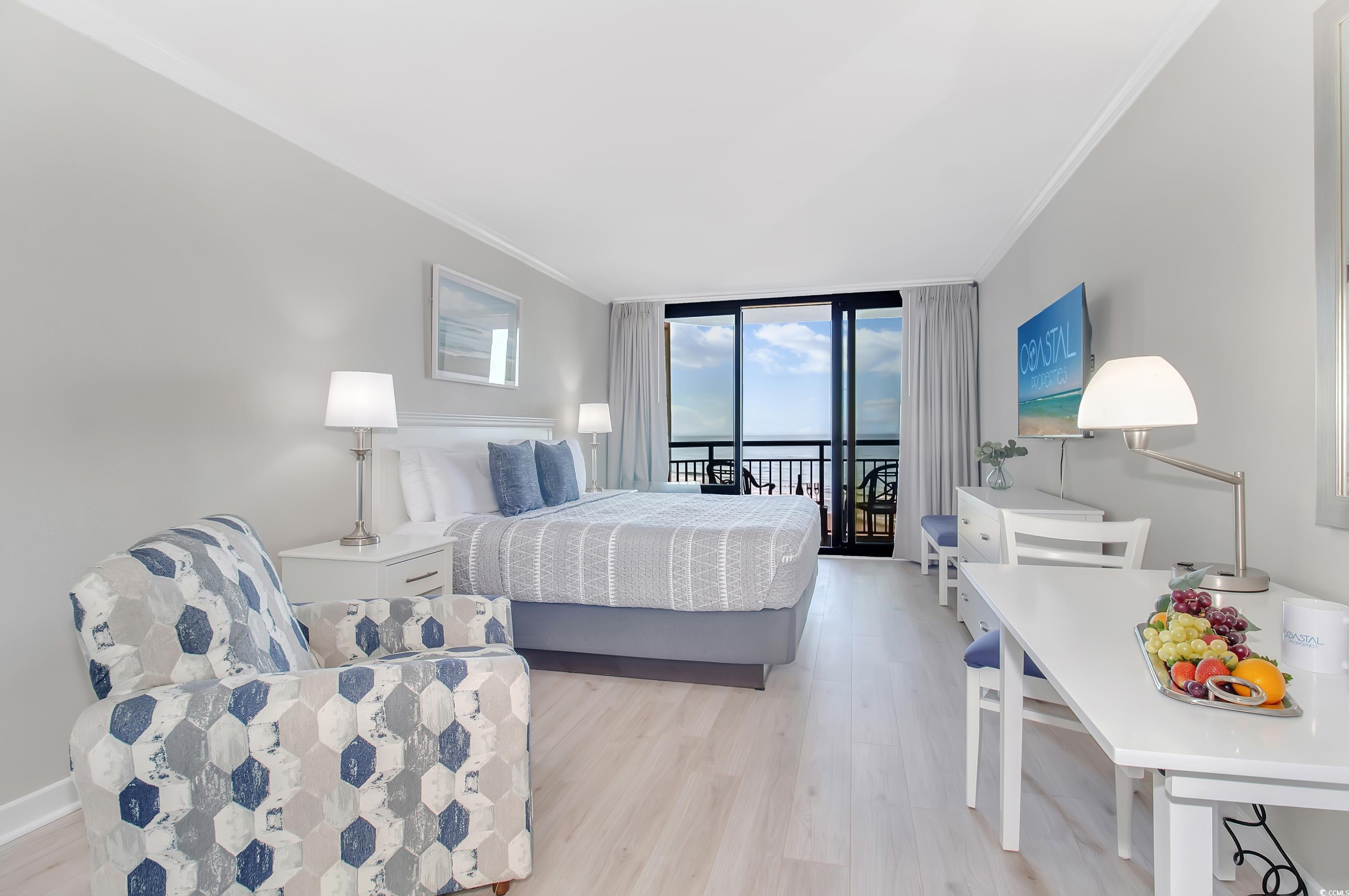 2710 North Ocean Boulevard, Unit 622 Myrtle Beach, SC 29577 - Photo 26 of 37 Bedroom with floor to ceiling windows, access to outside, light wood-style flooring, and crown molding