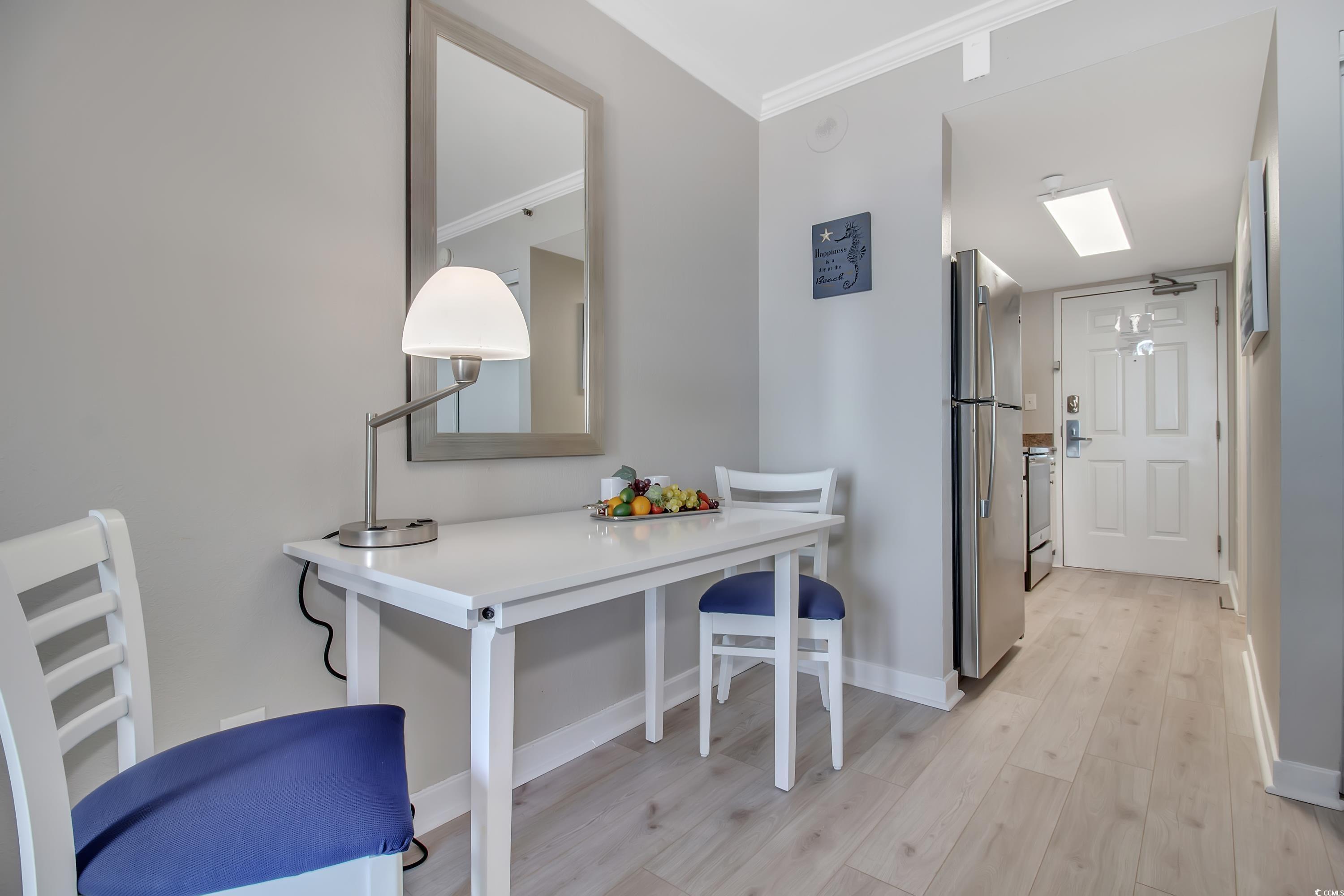 2710 North Ocean Boulevard, Unit 622 Myrtle Beach, SC 29577 - Photo 30 of 37 Dining area featuring crown molding and light wood-style flooring