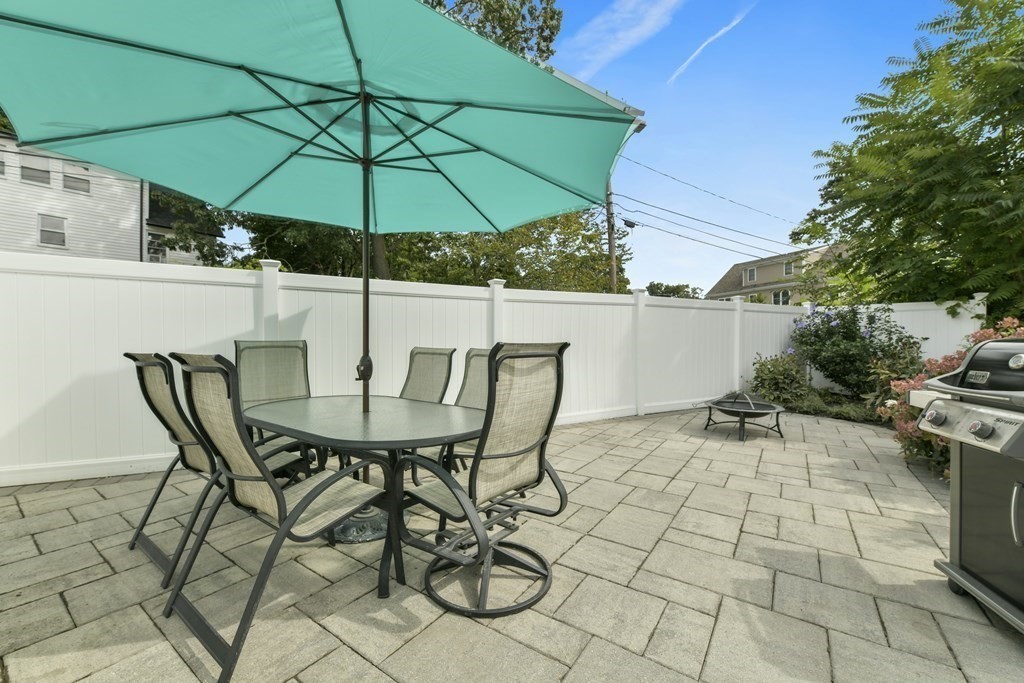21 Stella Road Boston, MA 02131 - Photo 11 of 22 a view of patio with table and chairs under an umbrella