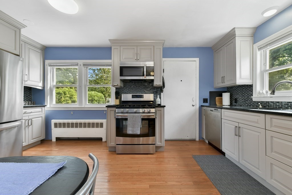 21 Stella Road Boston, MA 02131 - Photo 13 of 22 a kitchen with stainless steel appliances a stove a sink a microwave and a refrigerator
