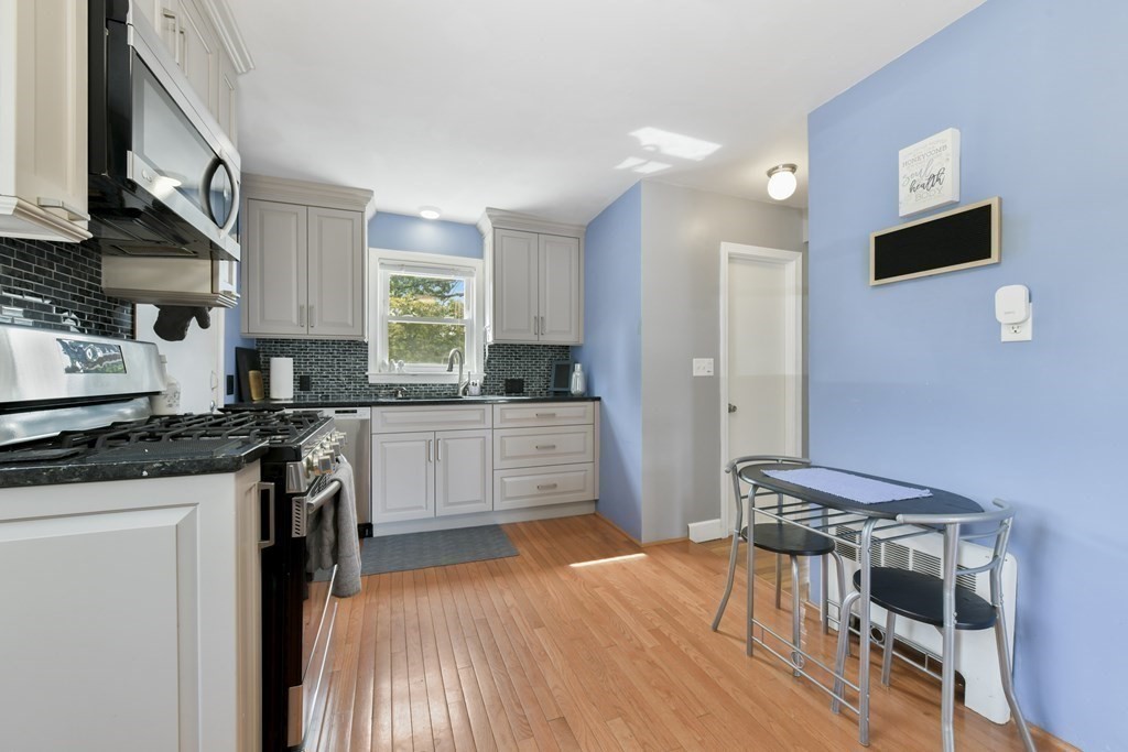 21 Stella Road Boston, MA 02131 - Photo 14 of 22 a kitchen with stainless steel appliances granite countertop a refrigerator and a stove top oven