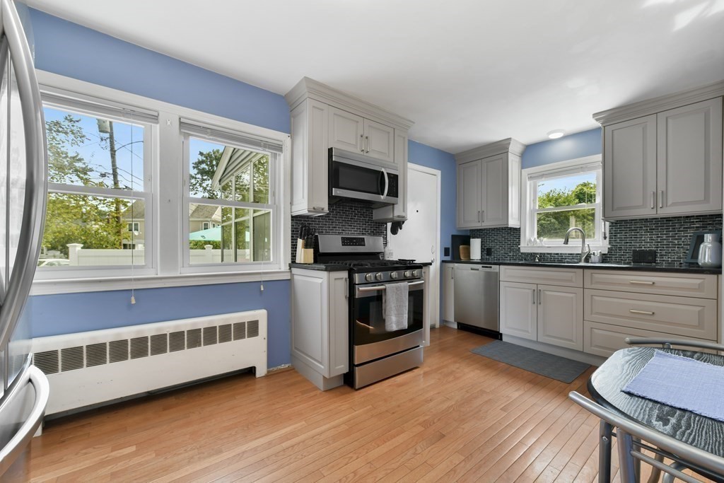 21 Stella Road Boston, MA 02131 - Photo 15 of 22 a kitchen with a window a sink and a stove top oven