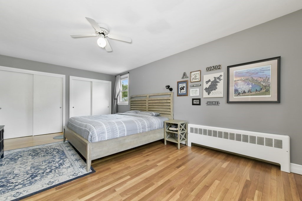 21 Stella Road Boston, MA 02131 - Photo 17 of 22 a bedroom with a bed and a chandelier