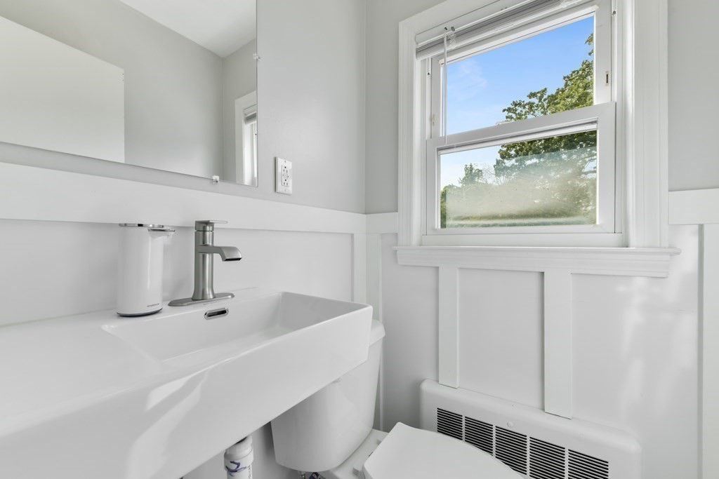 21 Stella Road Boston, MA 02131 - Photo 20 of 22 a bathroom with a sink a toilet and mirror