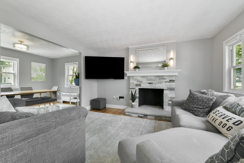 21 Stella Road Boston, MA 02131 - Photo 2 of 22 a living room with furniture a flat screen tv and a fireplace