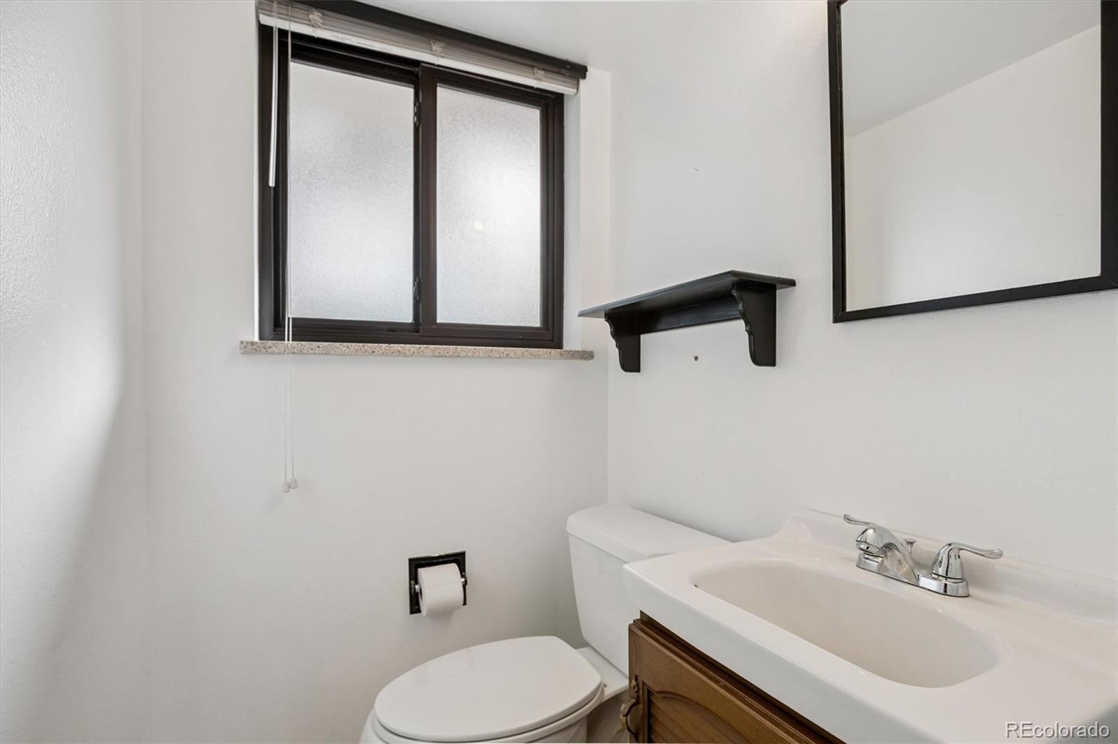6193 South Jackson Street Centennial, CO 80121 - Photo 17 of 31 a bathroom with a toilet sink and mirror