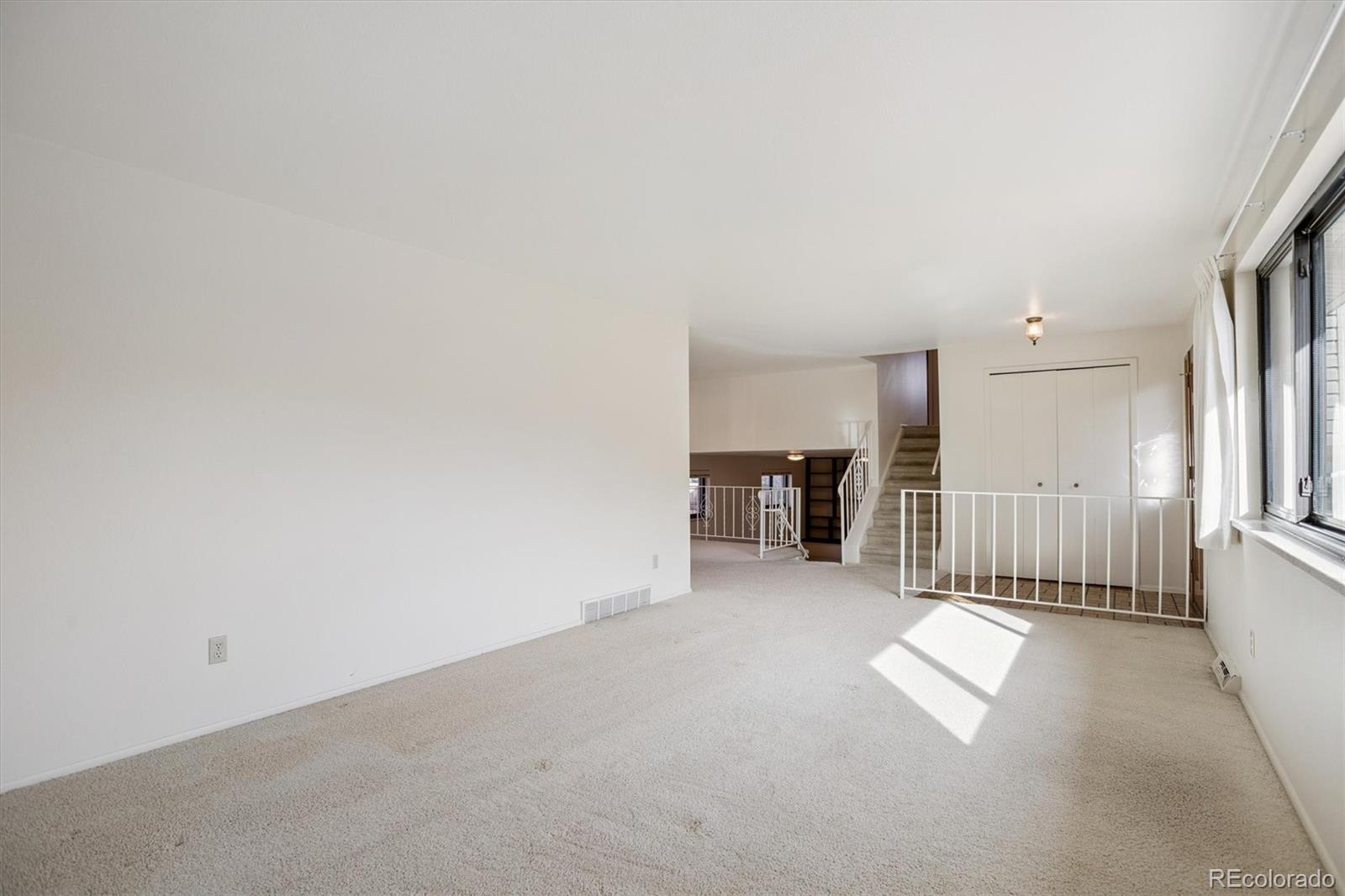 6193 South Jackson Street Centennial, CO 80121 - Photo 5 of 31 a view of a livingroom with a staircase