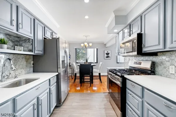 a kitchen with stainless steel appliances a stove sink microwave and cabinets